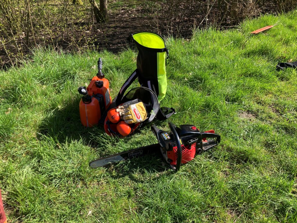 chainsaw, fuel can, helmet, gloves